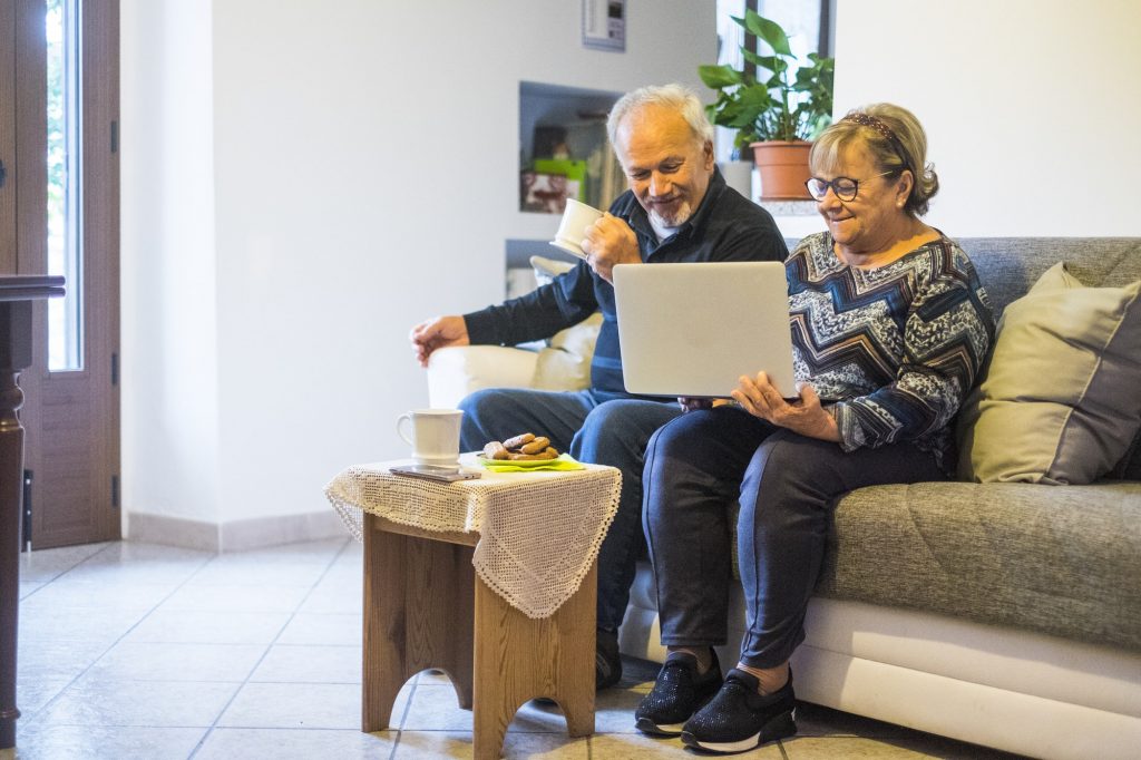 Retired senior people at home enjoying and use technology